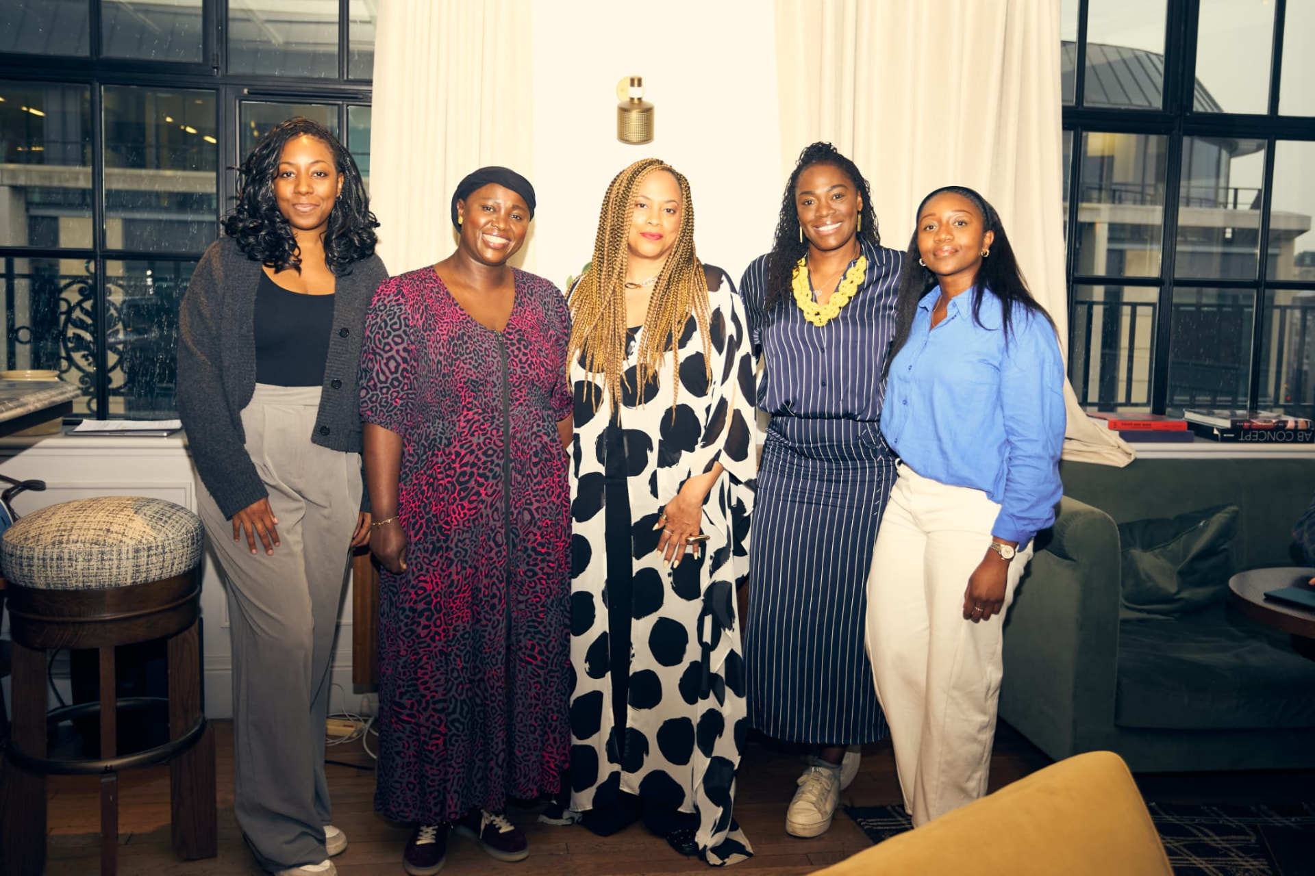 Five panel contributors standing together