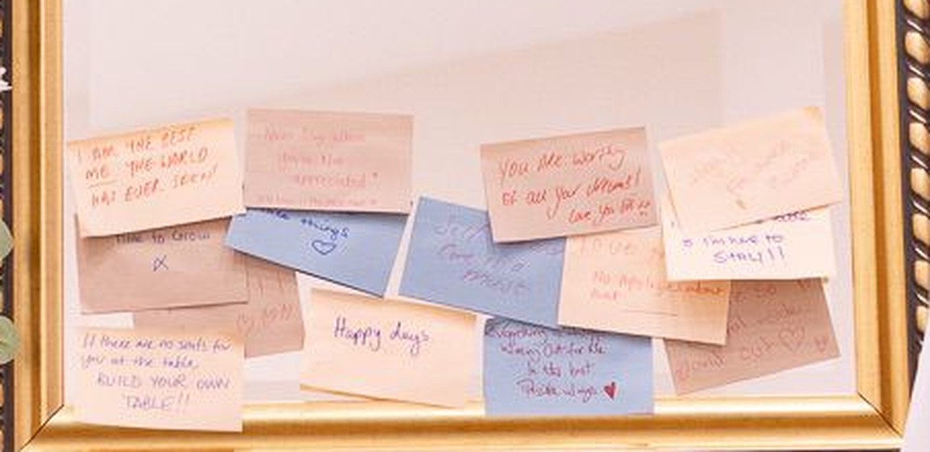 Handwritten affirmation notes left on the mirror