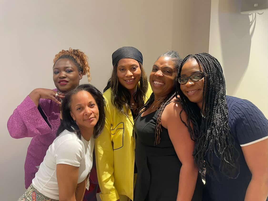 Five women standing together, smiling, at The Repositioning